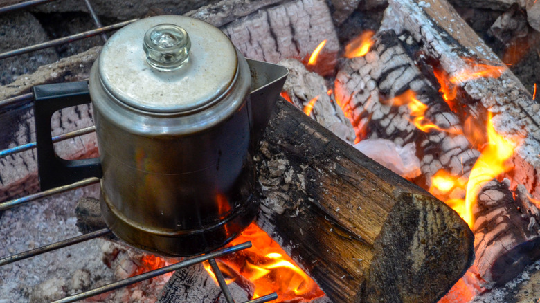Coffee pot over a campfire