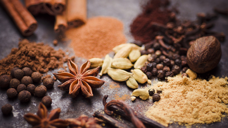 A closeup of various whole and ground spices