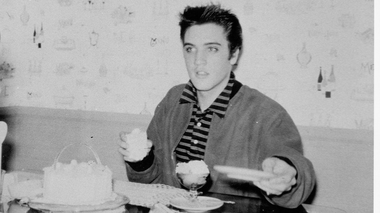 Singer Elvis Presley eating ice cream and cake