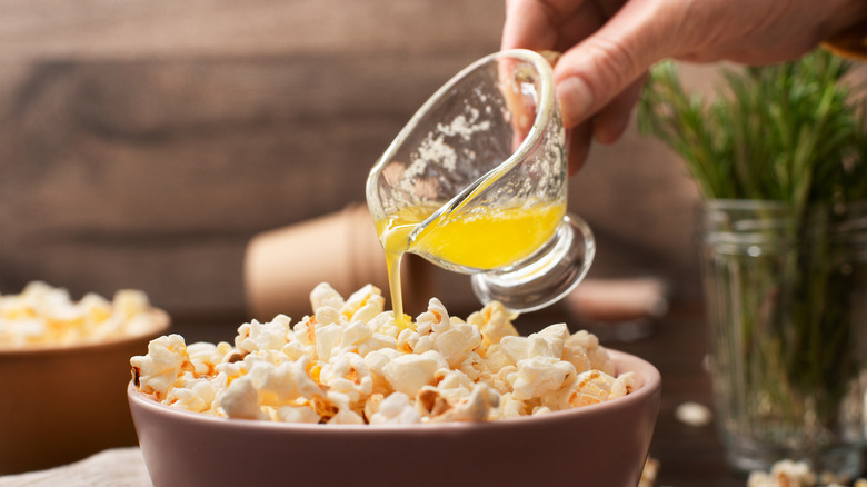 Pouring butter on popcorn