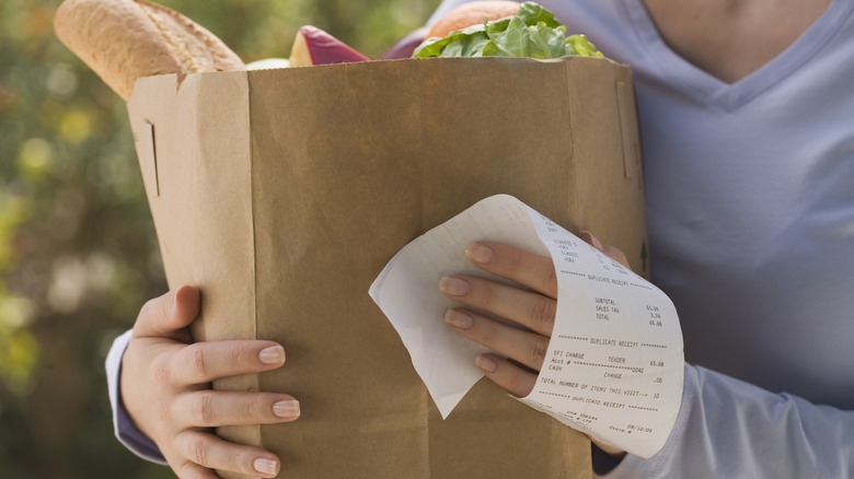 Woman holding full grocery bag