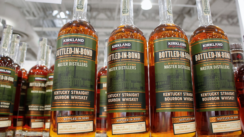 Bottles of Kirkland Signature Bourbon whisky on a shelf at a Costco warehouse