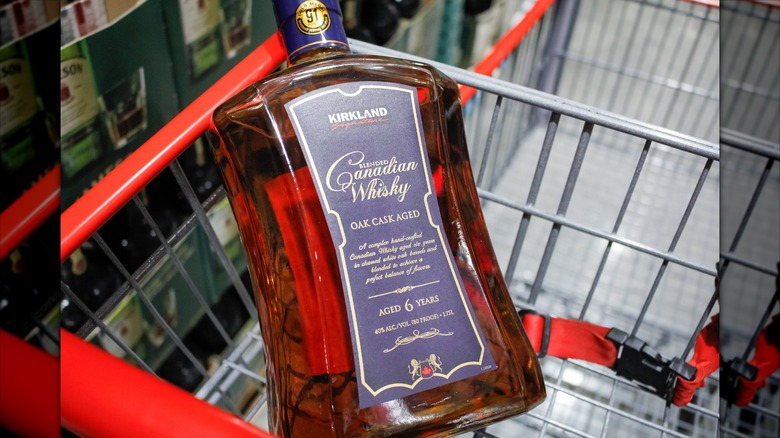 A bottle of Kirkland Signature Canadian whisky in a cart at Costco