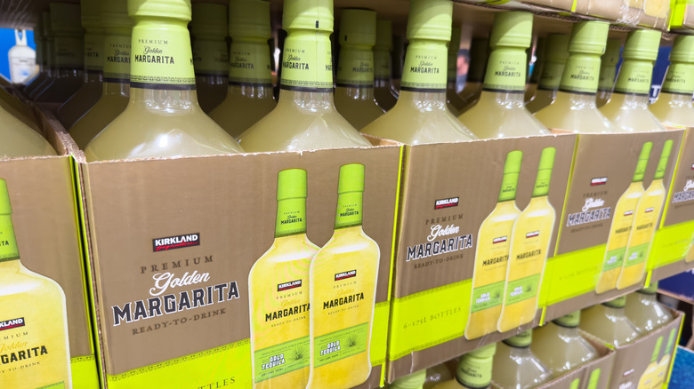 Boxes of Kirkland Signature Golden Margarita on a shelf at a Costco warehouse