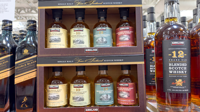 A sampler box of Kirkland Signature Scotch Whisky bottles on a shelf at a Costco warehouse