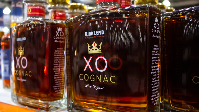 Bottles of Kirkland Signature XO Cognac on a shelf at a Costco warehouse