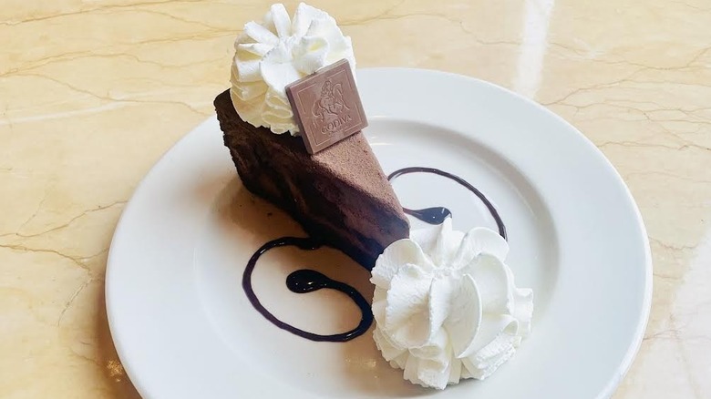 A slice of The Cheesecake Factory's Godiva Chocolate Cheesecake is shown.