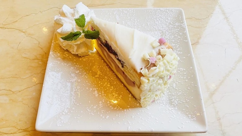 A slice of The Cheesecake Factory's Triple Berry Bliss Cheesecake is shown.