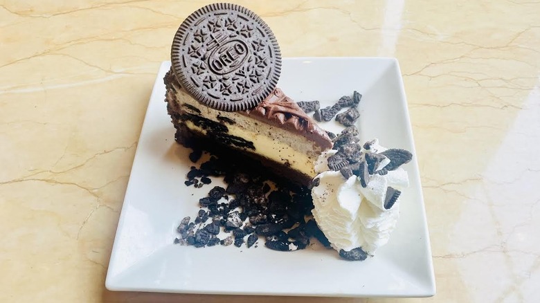 A slice of The Cheesecake Factory's Oreo Dream Extreme Cheesecake is shown.