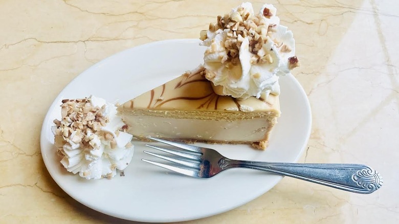 A slice of The Cheesecake Factory's Dulce De Leche Caramel Cheesecake is shown.