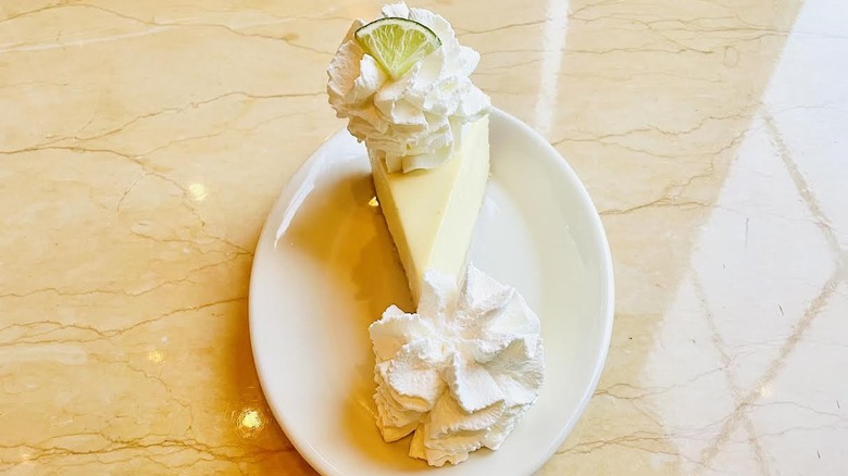 A slice of The Cheesecake Factory's Key Lime Cheesecake is shown.