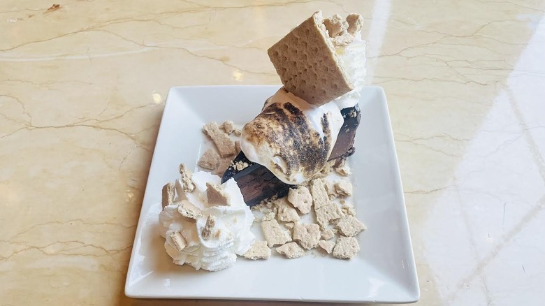 A slice of The Cheesecake Factory's Toasted Marshmallow S'Mores Galore Cheesecake is shown.
