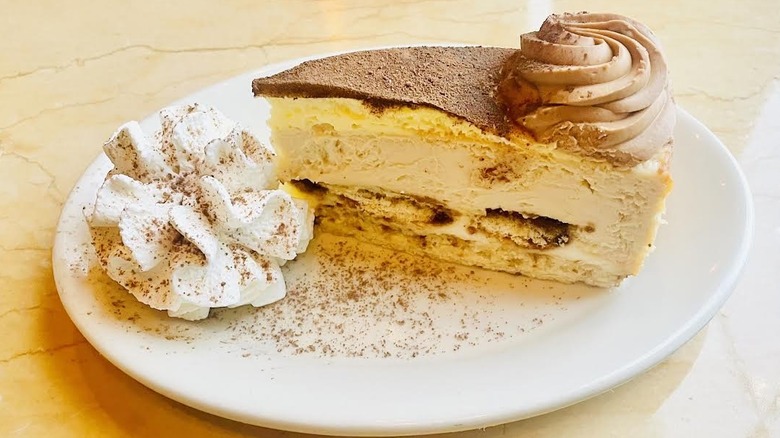 A slice of The Cheesecake Factory's Tiramisu Cheesecake is shown.