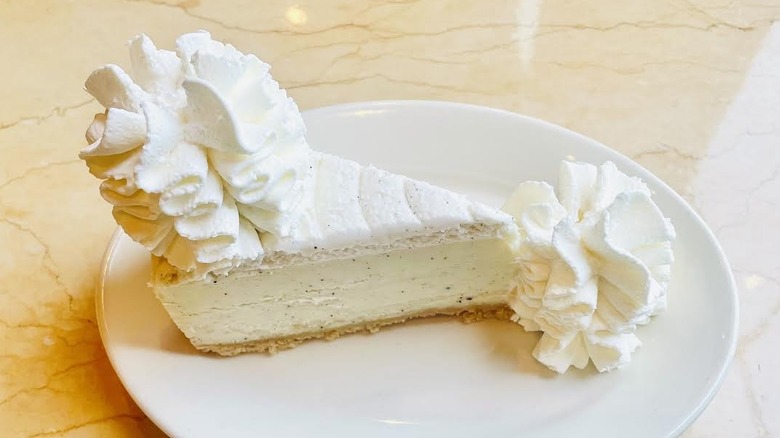 A slice of The Cheesecake Factory's Vanilla Bean Cheesecake is shown.
