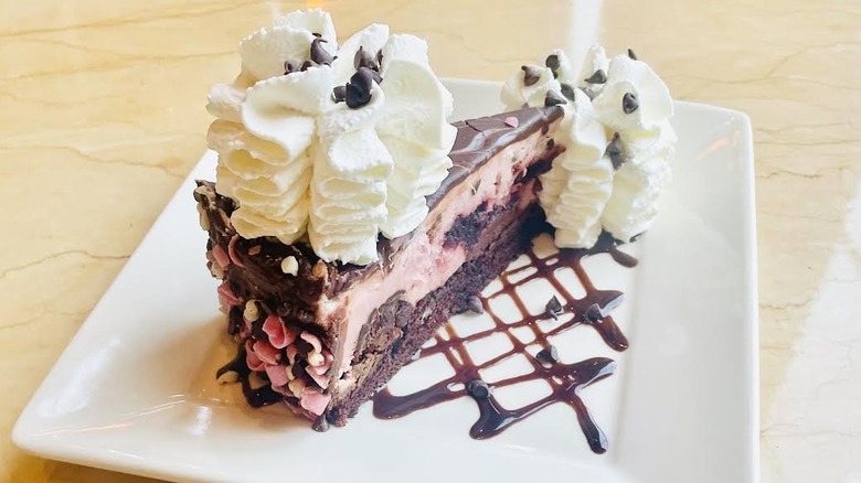 A slice of The Cheesecake Factory's Very Cherry Ghirardelli Chocolate Cheesecake is shown.