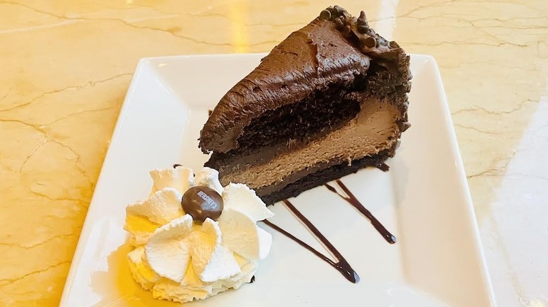 A slice of The Cheesecake Factory's Hershey's Chocolate Bar Cheesecake is shown.