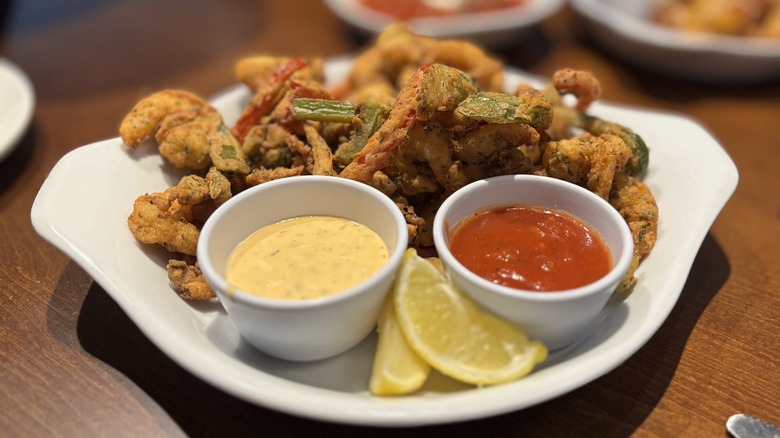 Olive Garden Shrimp Fritto Misto with dipping sauces and lemon wedges on plate on table
