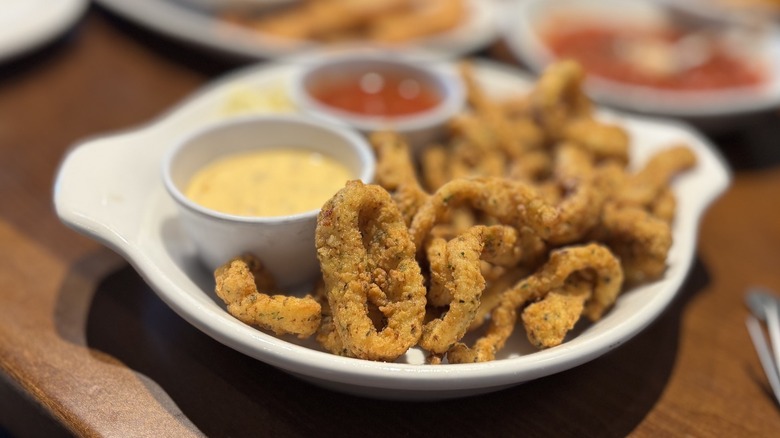 Olive Garden Calamari with dipping sauces on plate on table