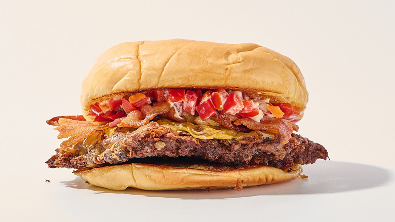 bacon and pepper burger on a table