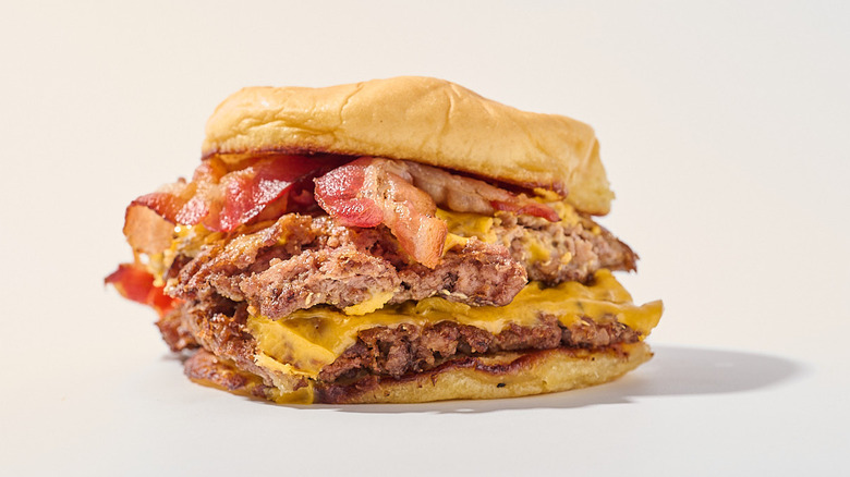 bacon cheeseburger on a table