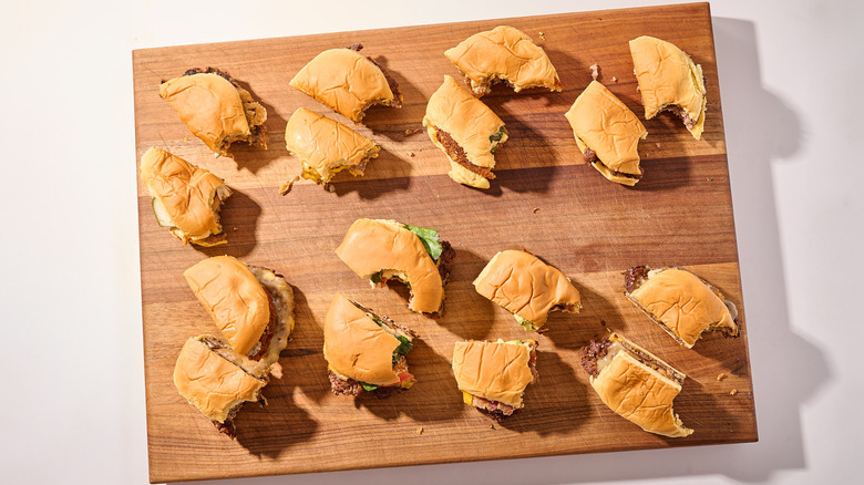 Halved hamburgers on a cutting board