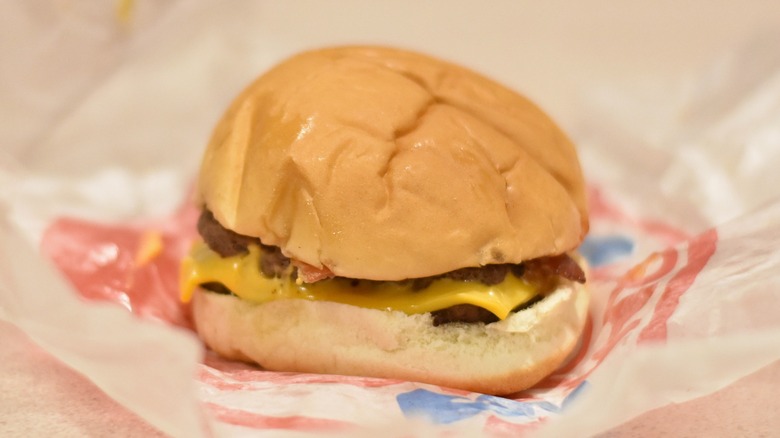 A double stack burger with cheese on a large bun