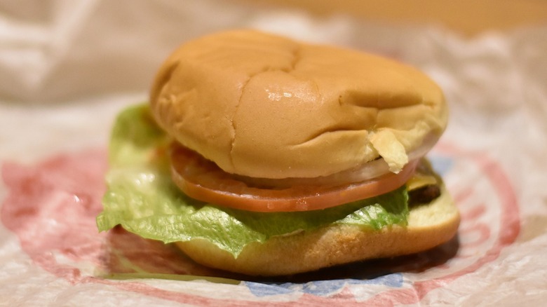 A burger with lettuce and tomato on a bun