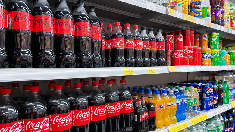 Cans of Coca-Cola on store shelves