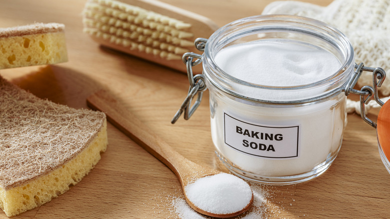 A jar of baking soda and cleaning items are displayed.