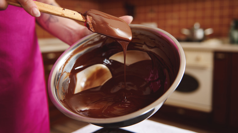 Person stirring melted chocolate