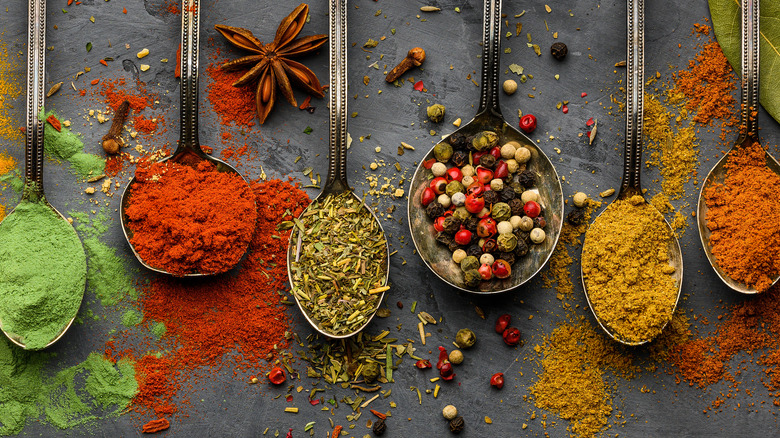 colorful spices on gray background