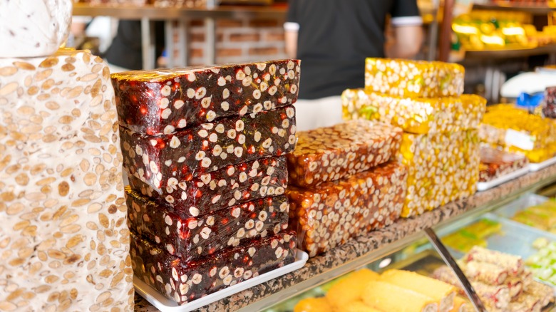 Various colored blocks of nougat are on display in a bakery.