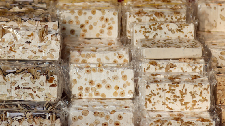 Blocks of packaged artisanal nougat are on display at a market in Italy.