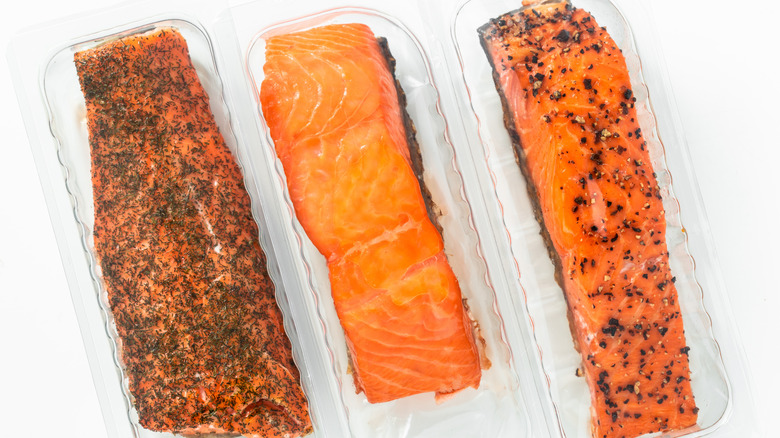 smoked salmon in sealed packages on white background