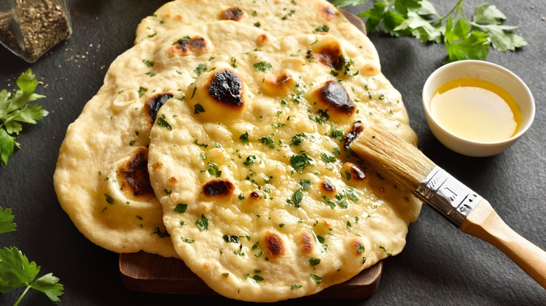 Brushing naans with butter