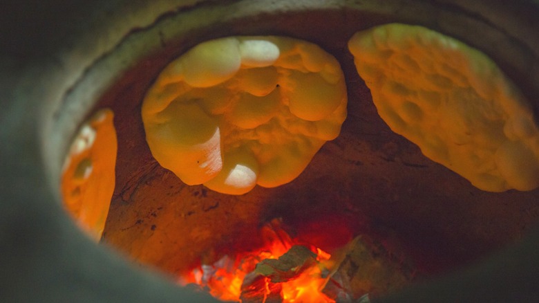 Naan baking in a tandoor