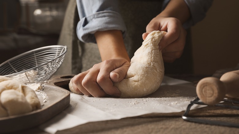 woman kneading challah dough