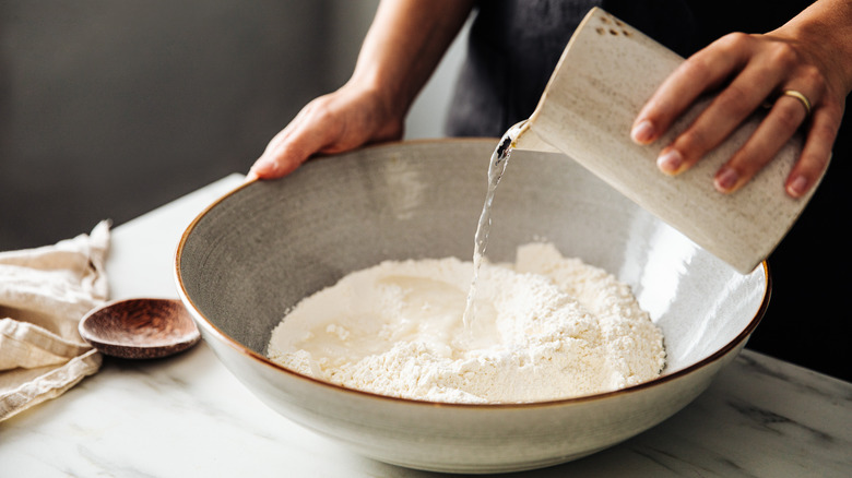 woman mixing flour and water