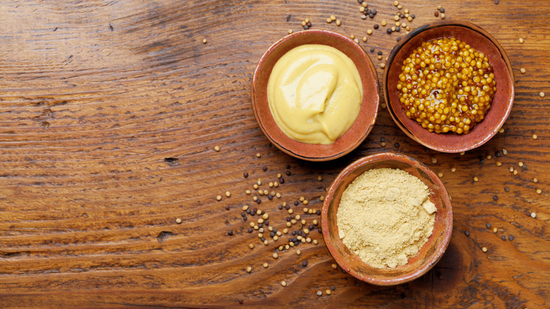 three bowls of different mustards