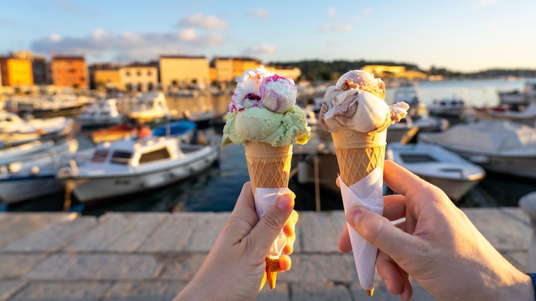 Two hands holding ice cream cones