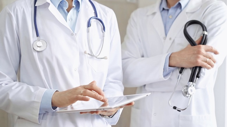 doctors looking at a tablet