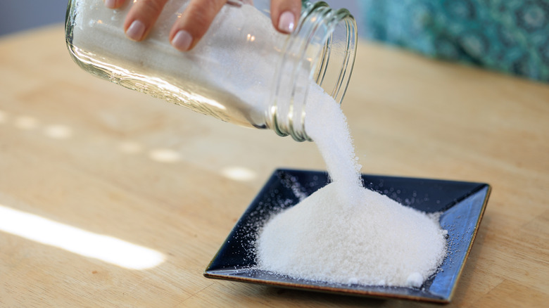 Pouring sugar from jar