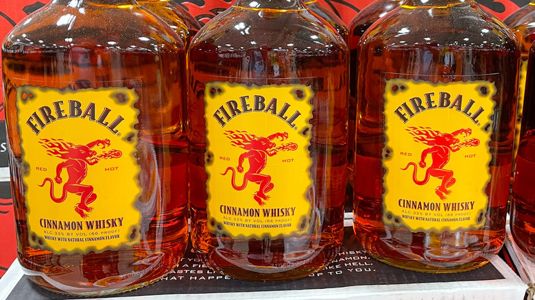 Three bottles of Fireball Cinnamon Whisky at the grocery store