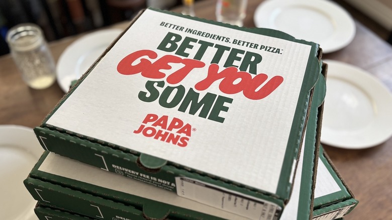 stack of Papa Johns pizza boxes