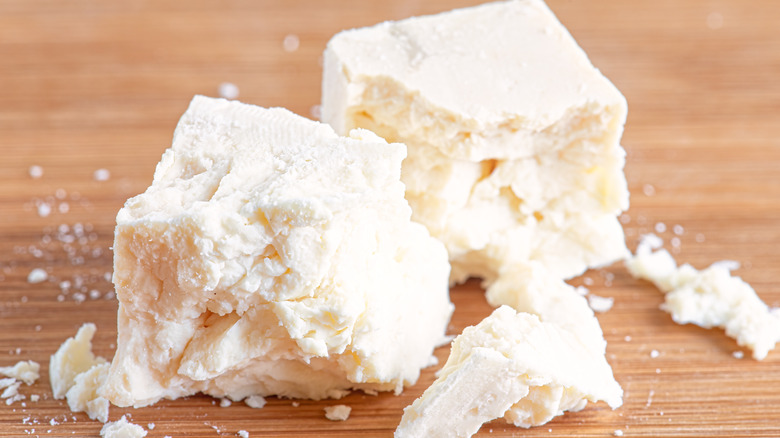 Feta cheese crumbles on a wooden table