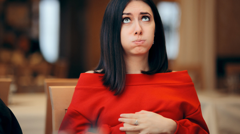 Woman with hand on stomach from feeling full