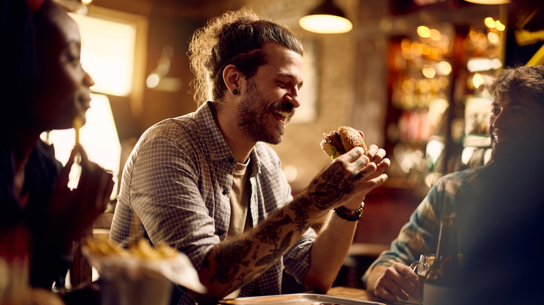 Man eating burger in restaurant