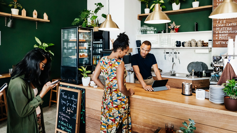 Woman ordering coffee in café