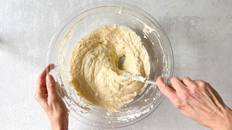 Folding whipped egg whites into fluffy lemon ricotta pancake batter