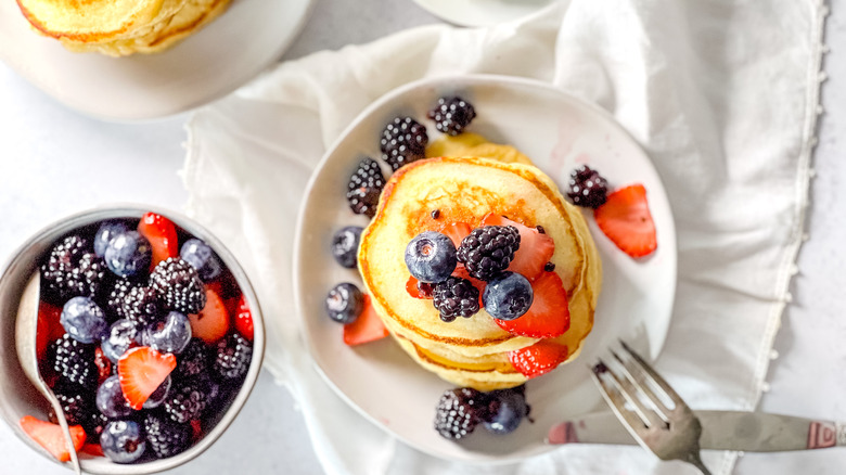 Fluffy lemon ricotta pancakes on plate with berries
